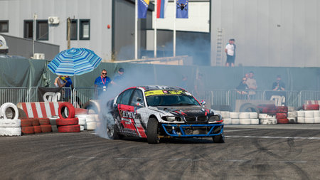 Car drifting on track with lots of smoke from burning tires