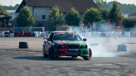Car drifting on track with lots of smoke from tires