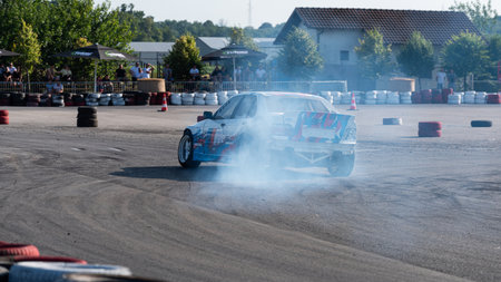 Car drifting on track with lots of smoke from burning tires