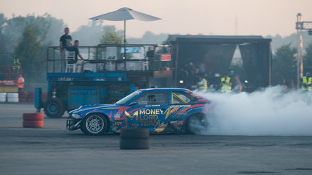 Car drifting on track with lots of smoke from burning tires