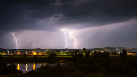 Multiple lightning during thunderstorm at night, over hills near croatian city of Slavonski Brod