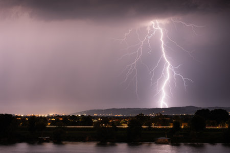Beautiful lightning during thunderstorm at night, over hills near croatian city of Slavonski Brodの写真素材