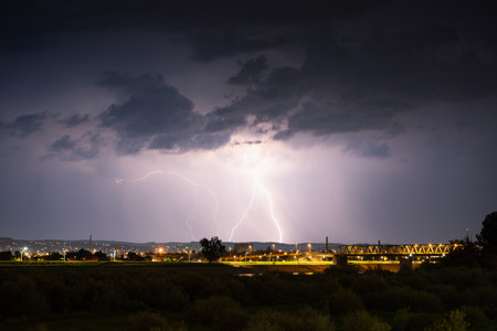 Multiple lightning during thunderstorm at night, over hills near croatian city of Slavonski Brod