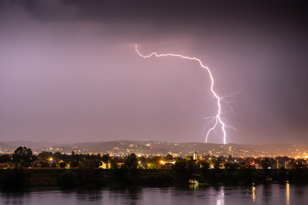 Beautiful lightning during thunderstorm at night, over hills near croatian city of Slavonski Brodの写真素材