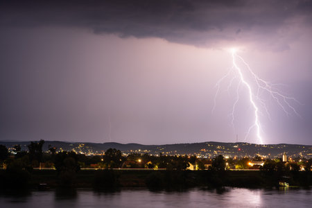 Beautiful lightning during thunderstorm at night, over hills near croatian city of Slavonski Brodの写真素材