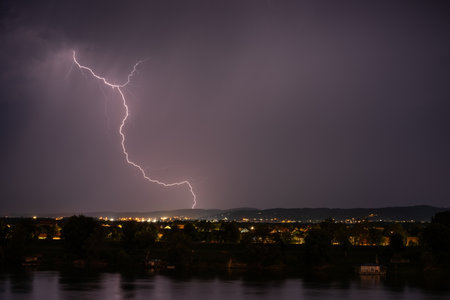 Beautiful lightning during thunderstorm at night, over hills near croatian city of Slavonski Brodの写真素材