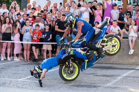 Moto tandem stunt ride show on street, freestyle stunt show in front of audienceのeditorial素材
