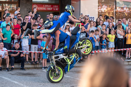 Moto tandem stunt ride show on street, freestyle stunt show in front of audienceのeditorial素材