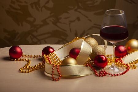 New Year's and Christmas arrangement with decorations and glasses of wineの写真素材