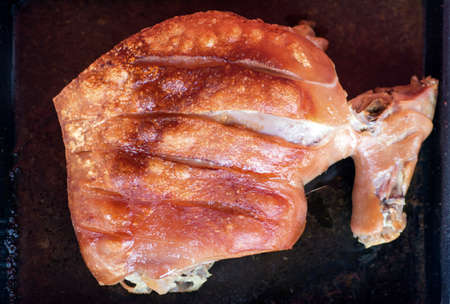 owen cooking roasted crunchy pork in plate with fat