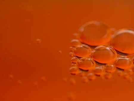Macro shot of water drops on orange background. Abstract background.の写真素材