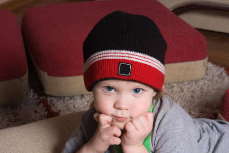 little boy with hat looking at us with hisの写真素材