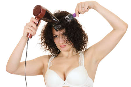 The woman dries the hair dryer hairの写真素材