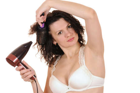 The woman dries the hair dryer hairの写真素材