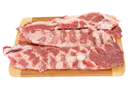 raw meat on a chopping board isolated on white background                               の写真素材