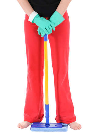 The woman in green gloves holds a mopの写真素材