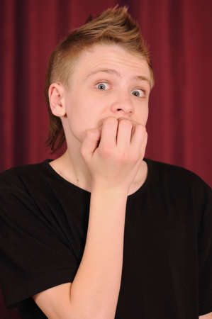 Portrait of the surprised teenager in a black vestの写真素材