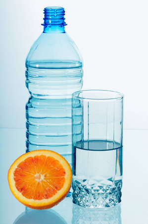 Water in a plastic bottle and a glass isolated on white backgroundの写真素材