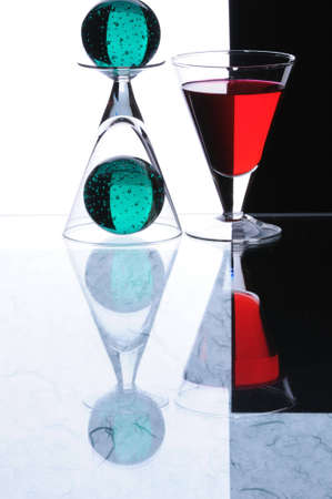 wineglasses and spheres isolated on white and black backgroundの写真素材