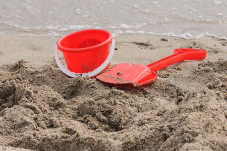 Red Sand Pail and Shovel on a beachの写真素材