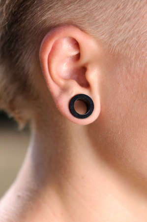 The big aperture in an ear at the teenagerの写真素材