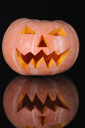  pumpkin with lighting candle inside on black backgroundの写真素材