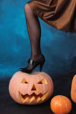 The leg of a witch costs on a pumpkinの写真素材