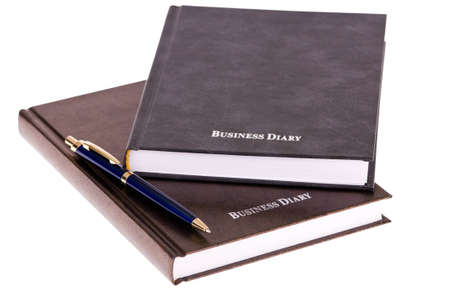 brown business diary with pen isolated on white backgroundの写真素材