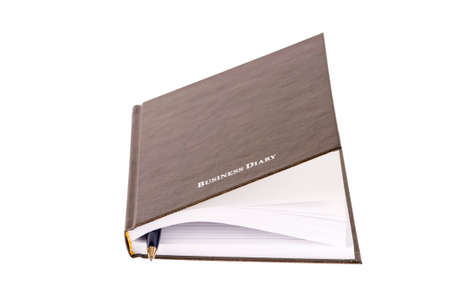 brown business diary with pen isolated on white backgroundの写真素材