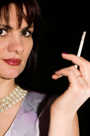 girl with a cigarette thoughtfully looking forwardの写真素材
