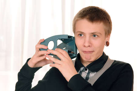 frightened teenager wants to pierce his ear puncherの写真素材