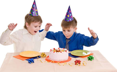 two happy boy with a cake isolated on white backgroundの写真素材