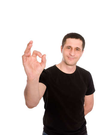 man in black t-shirt is showing sign ok isolated on white backgroundの写真素材