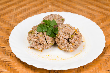 meatballs with salad and sauce on a white dishの写真素材