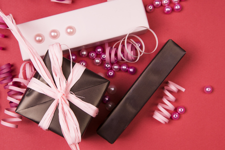 Set of gift boxes with bows, beads and ribbons on a colored backgroundの写真素材