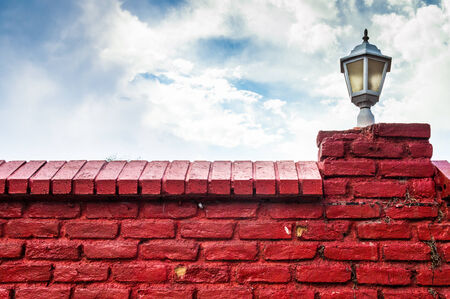 Red brick wall with lamp and beautiful sky view.の写真素材