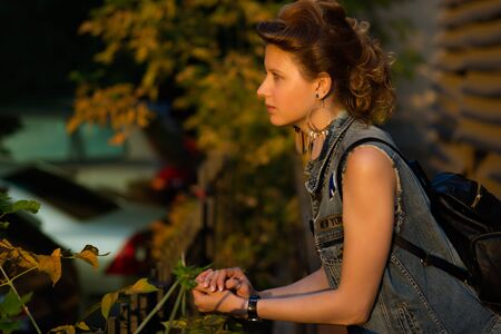 Beautiful woman outdoors enjoying summer sun. Wearing jeans jacket. Relaxing and calm.の写真素材