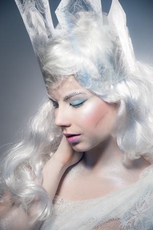 Winter Beauty Woman. Christmas Girl Makeup.Winter Queen with Snow and Ice crown. Close up view.の写真素材