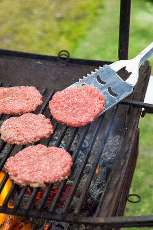 Flipping Hamburgers on the Grill with a Spatula