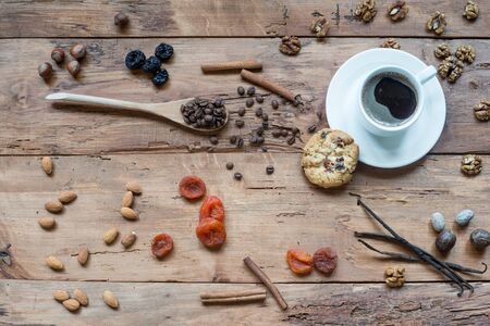 Coffee, chocolate, vanilla pods, cinnamon sticks, anise stars on wooden rustic tableの写真素材