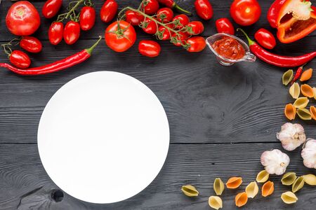 Healthy food background and Copy space / studio photography of raw tomatos  on black wooden table. Top view.の写真素材