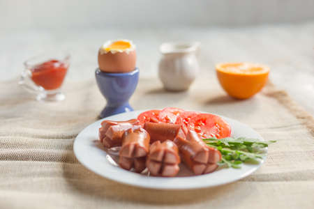 Breakfast in rustic style  boiled egg, sausage, salad, tomato, coffee)の写真素材