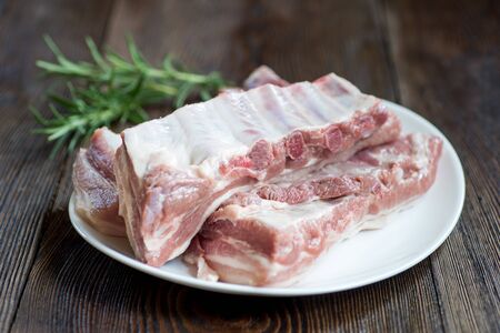 Raw pork belly with rosemarry,  rustic style.