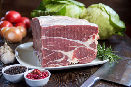 Raw meat, delicious veal, Beef Cheeks - best meat for tasteful gourmet slow cooking with vegetablesの写真素材