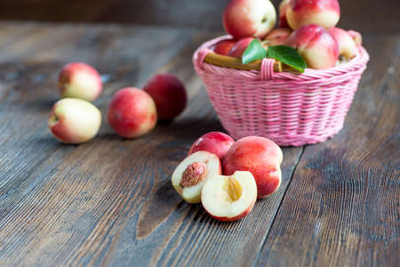 Nectarines composition close up on the wooden background.の写真素材