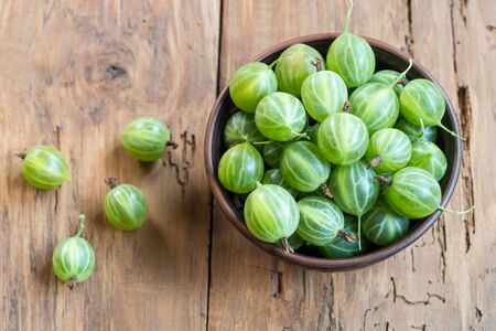 Raw gooseberries in bowl photographed overhead with natural light (Selective Focus, Focus on the gooseberries on the top)の写真素材