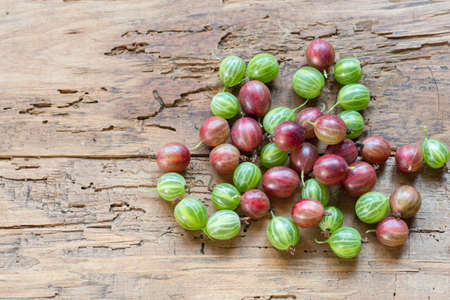 Organic gooseberries on old wooden background. Selective focusの写真素材