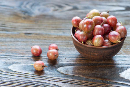 Raw gooseberries in bowl photographed overhead with natural light (Selective Focus, Focus on the gooseberries on the top)の写真素材