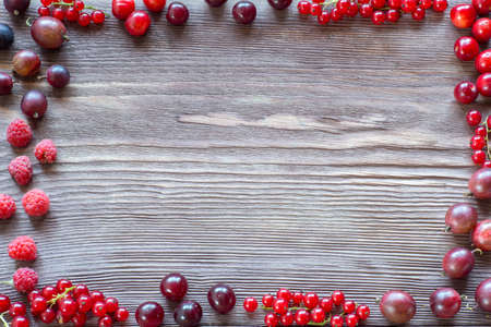 Berries on Wooden Background. Summer or Spring Organic Berry over Wood. Strawberries, Raspberries,...