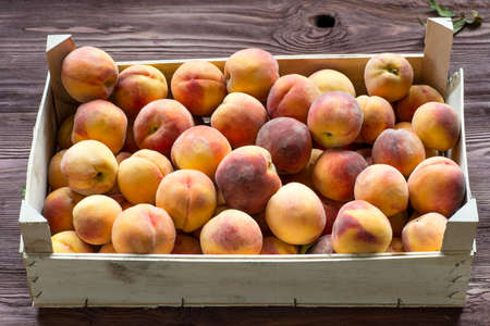 Fresh ripe peaches in the box ready for saleの写真素材